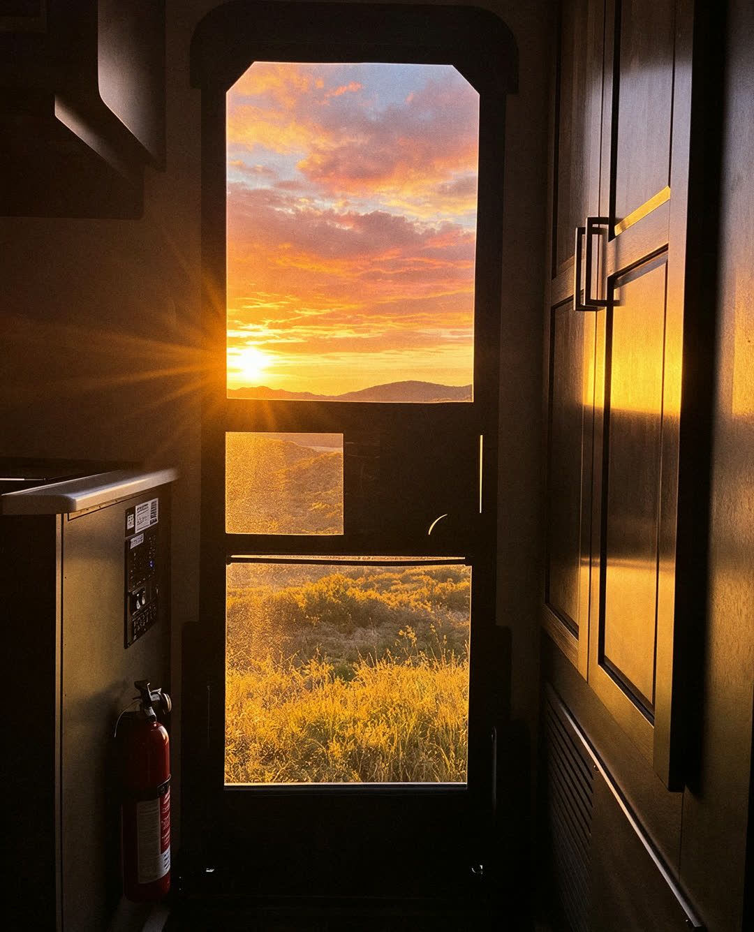 Sunset seen from inside the RV through the screen door with Clear View on it